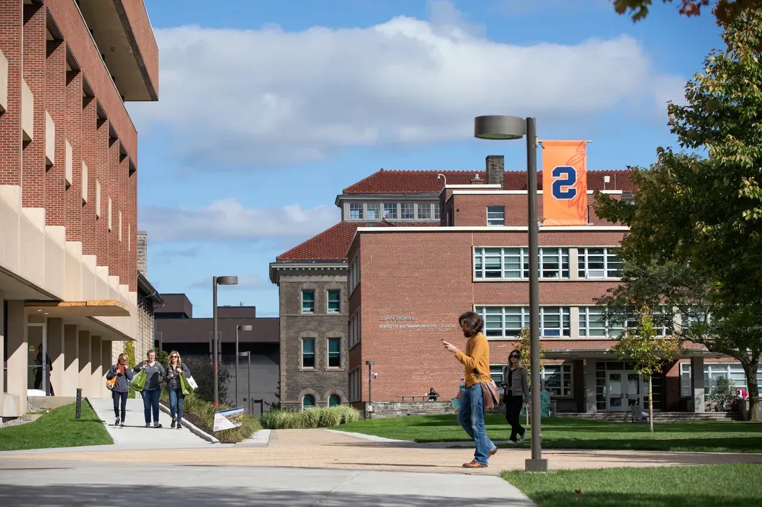 A person walking on a college campus.